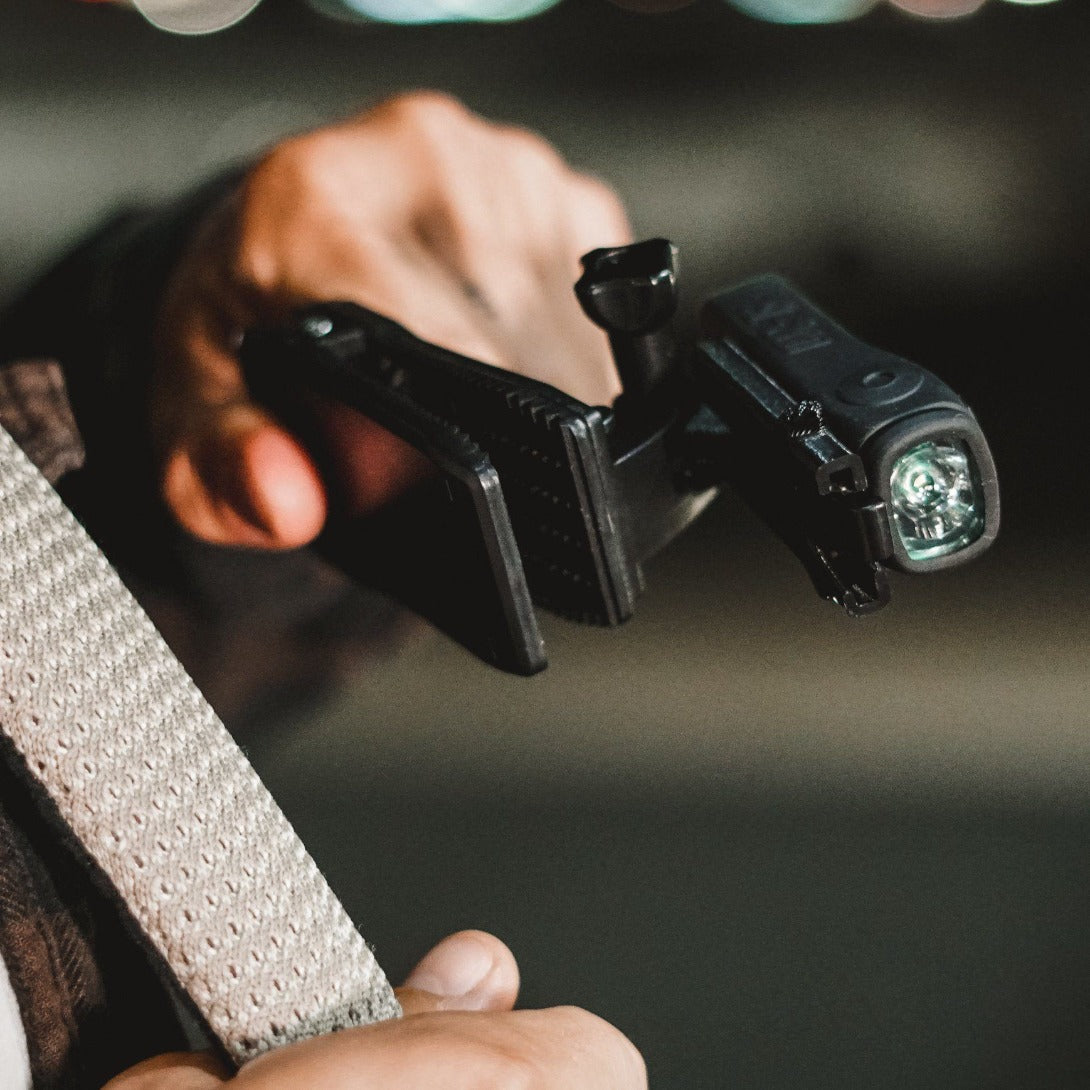 Action Clip by ShredLights in hand being clipped to strap.