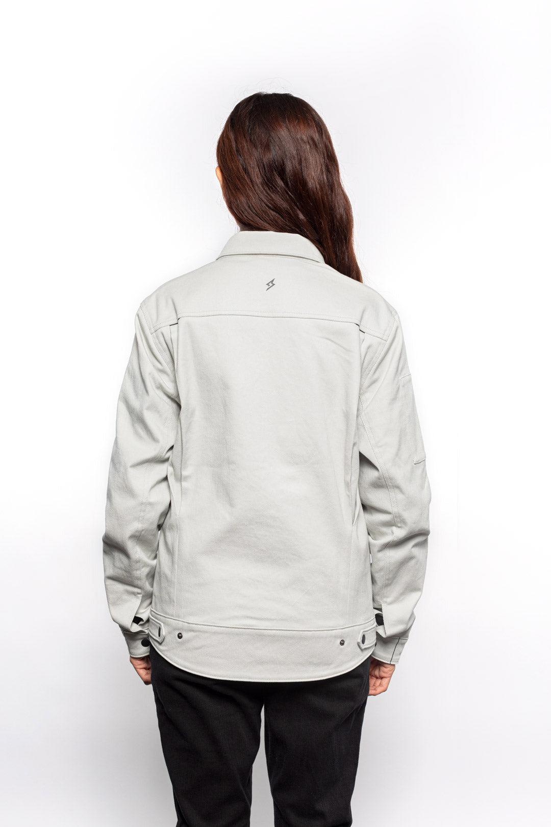 Back view of Female model wearing Anvil Chore Jacket in chalk colorway.
