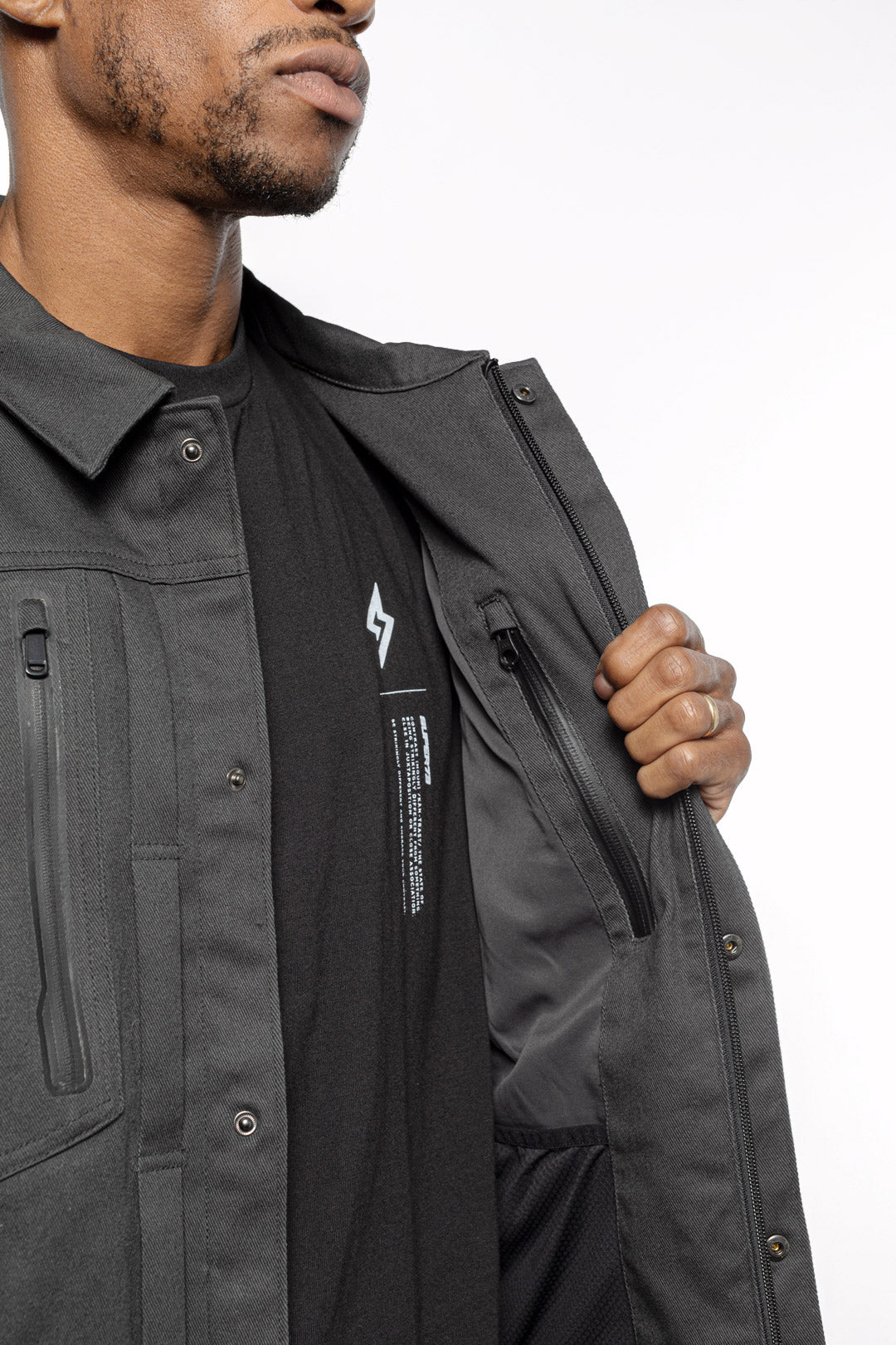 Male model showing inner details of Anvil Chore Jacket in gravel colorway.
