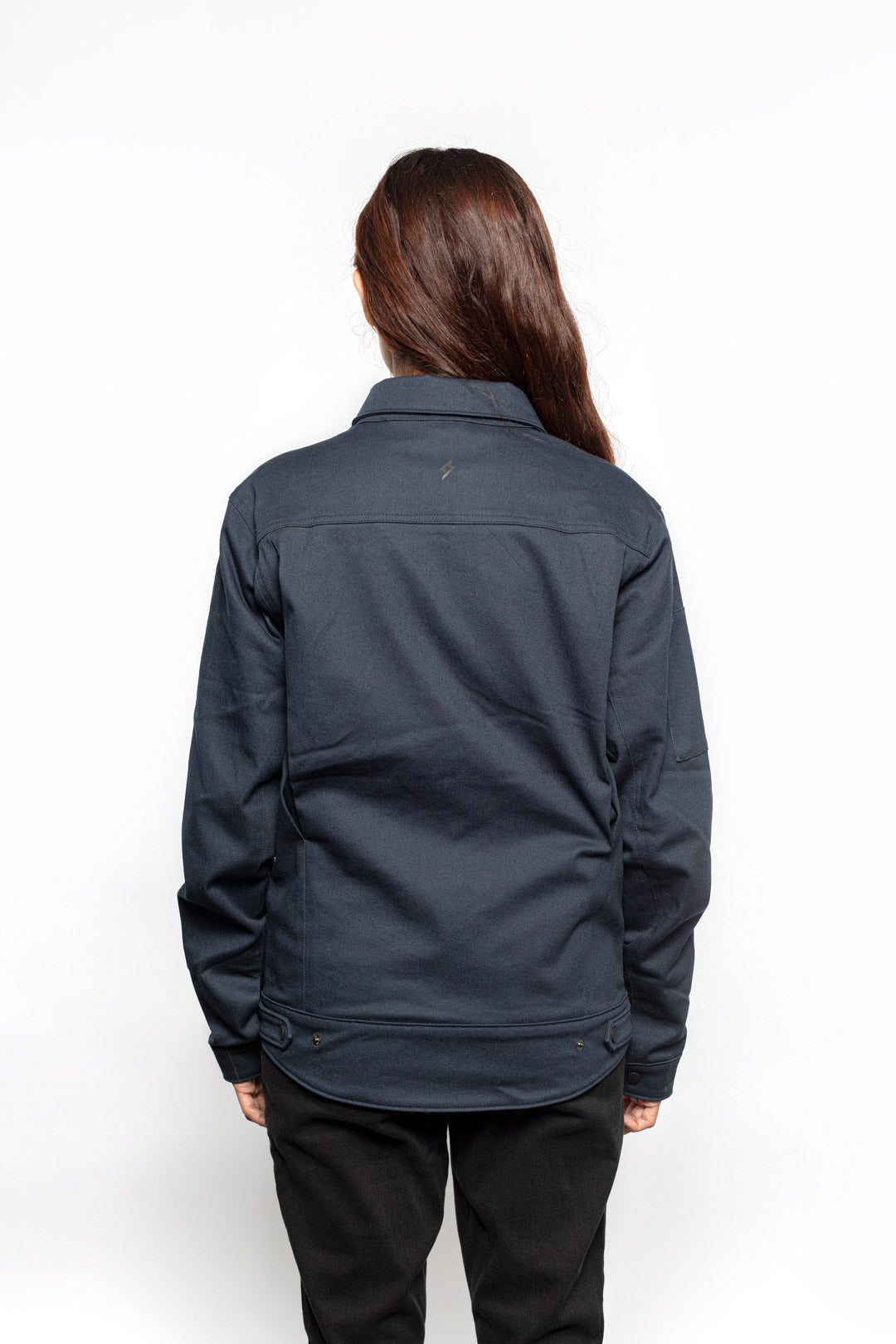 Back view of Female model wearing Anvil Chore Jacket in midnight colorway.