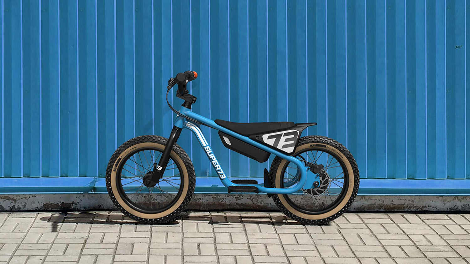 The new SUPER73-K1D electric kid's bike stands before a wall.