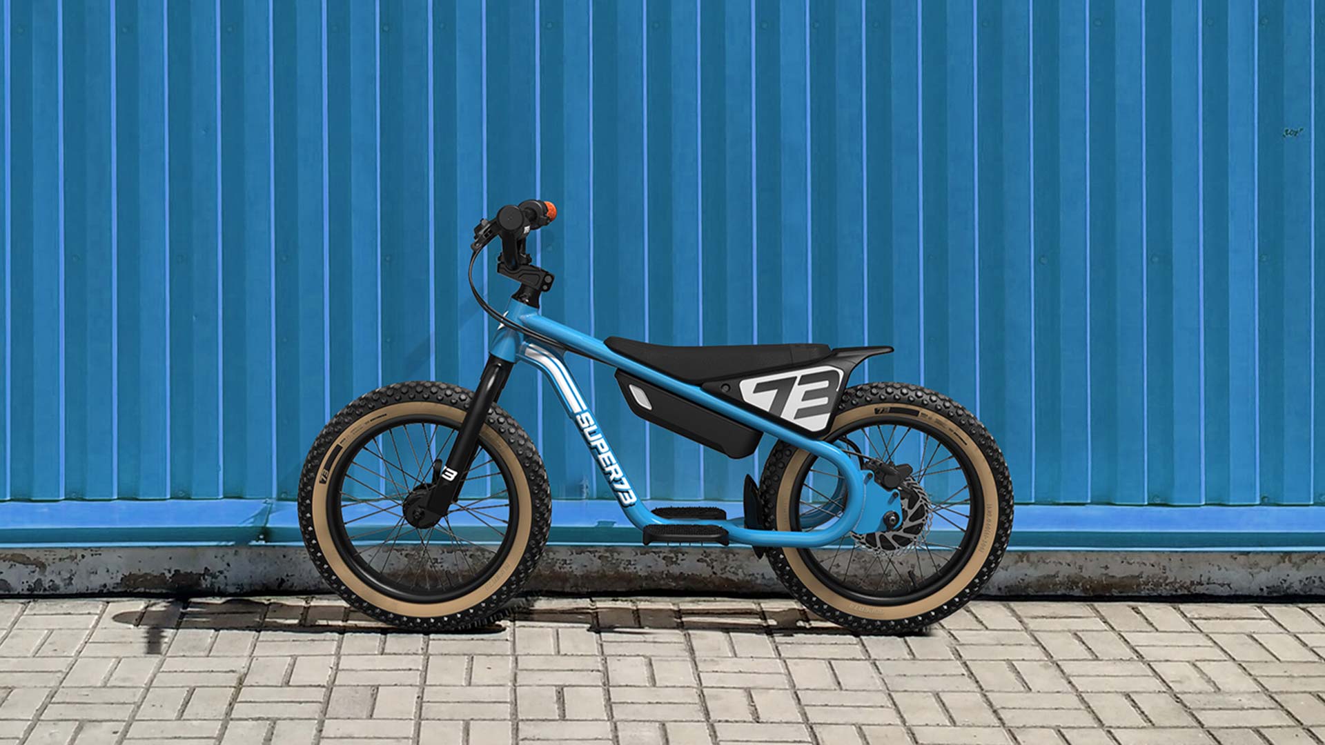 The new SUPER73-K1D electric kid's bike stands before a wall.