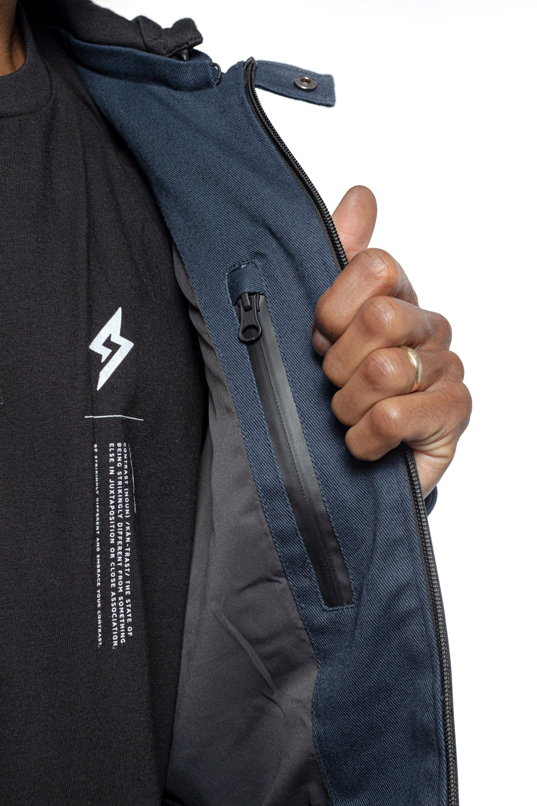 Male model showing inner details of Chisel Hooded Jacket in midnight colorway.