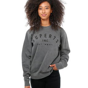 Front view of female model in Pigment Black Classic Crew Sweatshirt on white background.