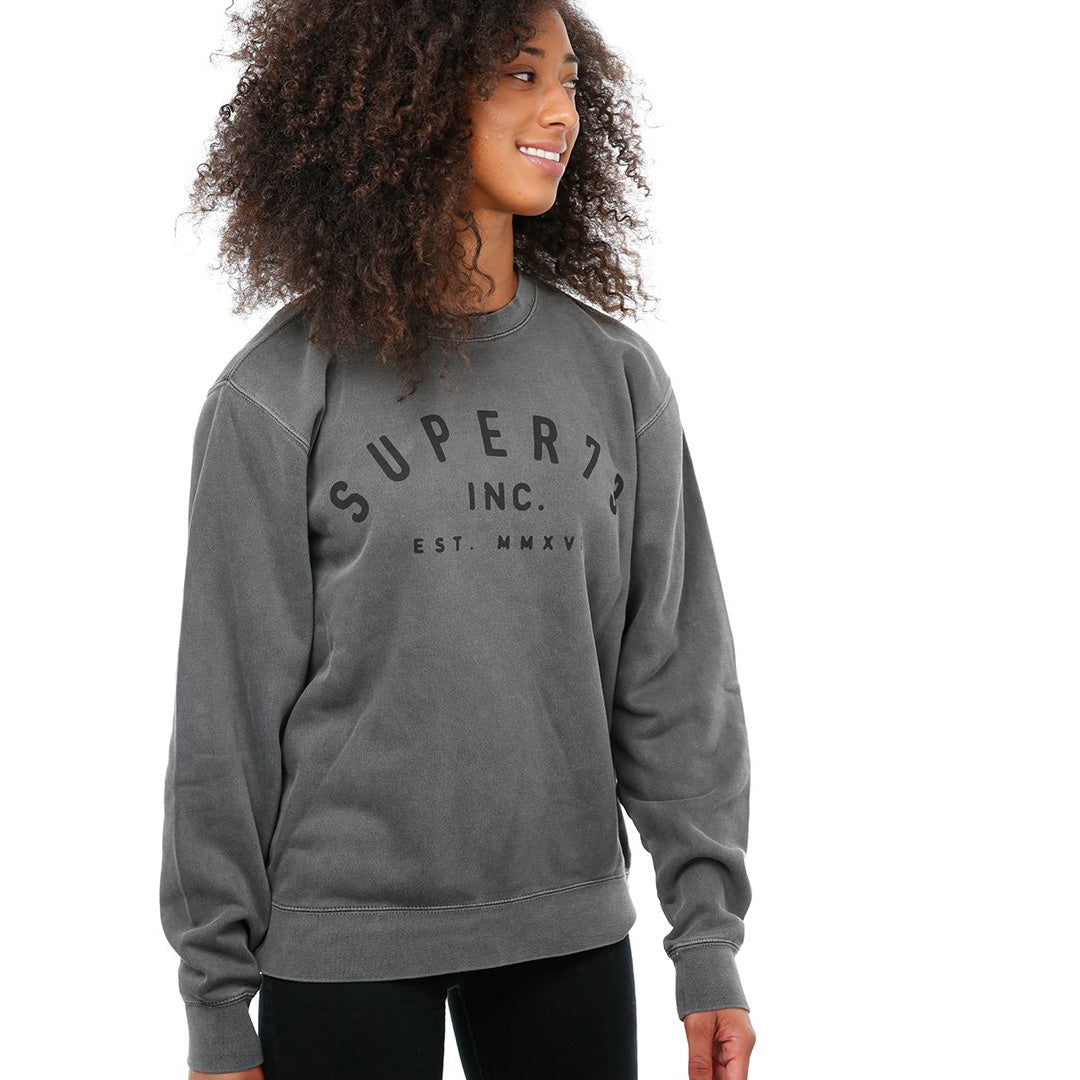 Front view of female model in Pigment Black Classic Crew Sweatshirt on white background.
