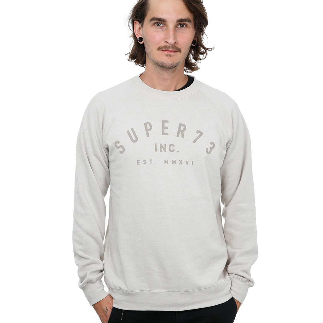 Front view of male model in Stone Classic Crew Sweatshirt on white background.
