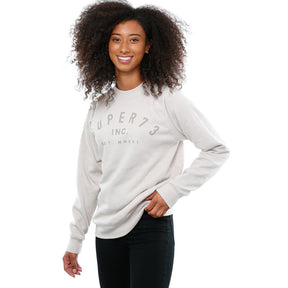 Side view of female model in Stone Classic Crew Sweatshirt on white background.