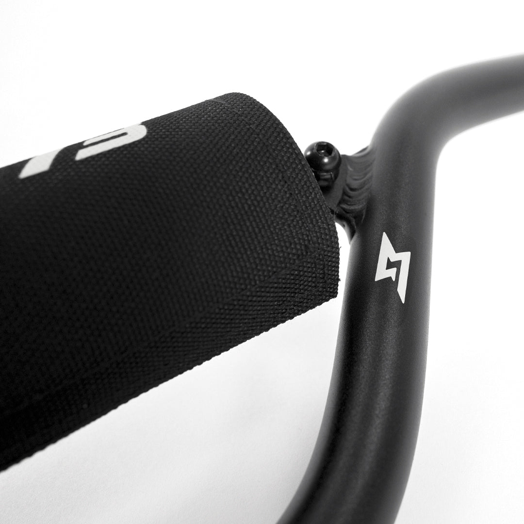 Detail view of The Tracker Mid Rise handlebar with logo.