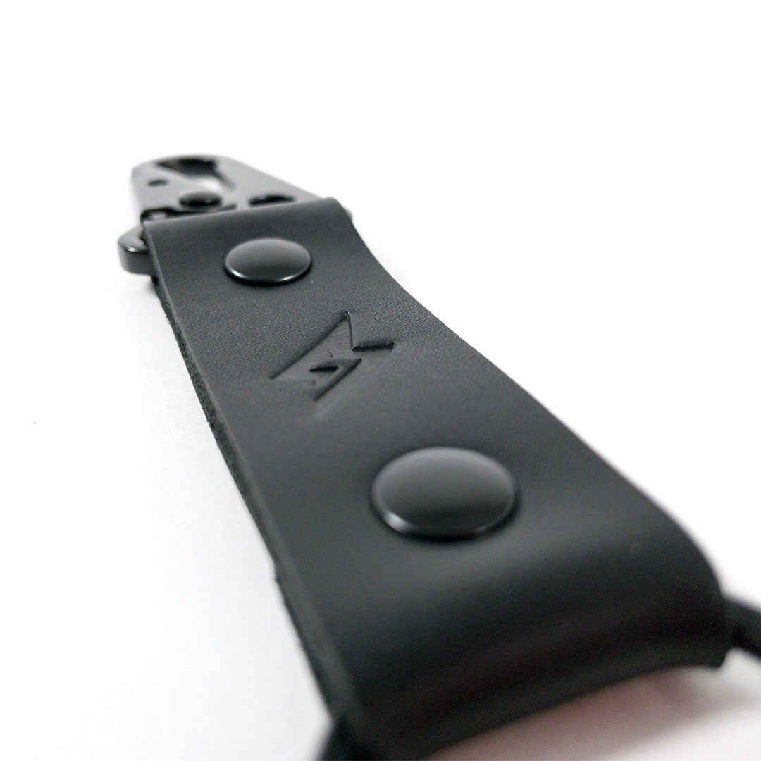 Angle detail view of Super73 leather keychain.