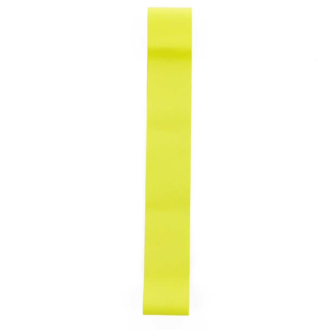 Single yellow tire liner strip layed out on white background