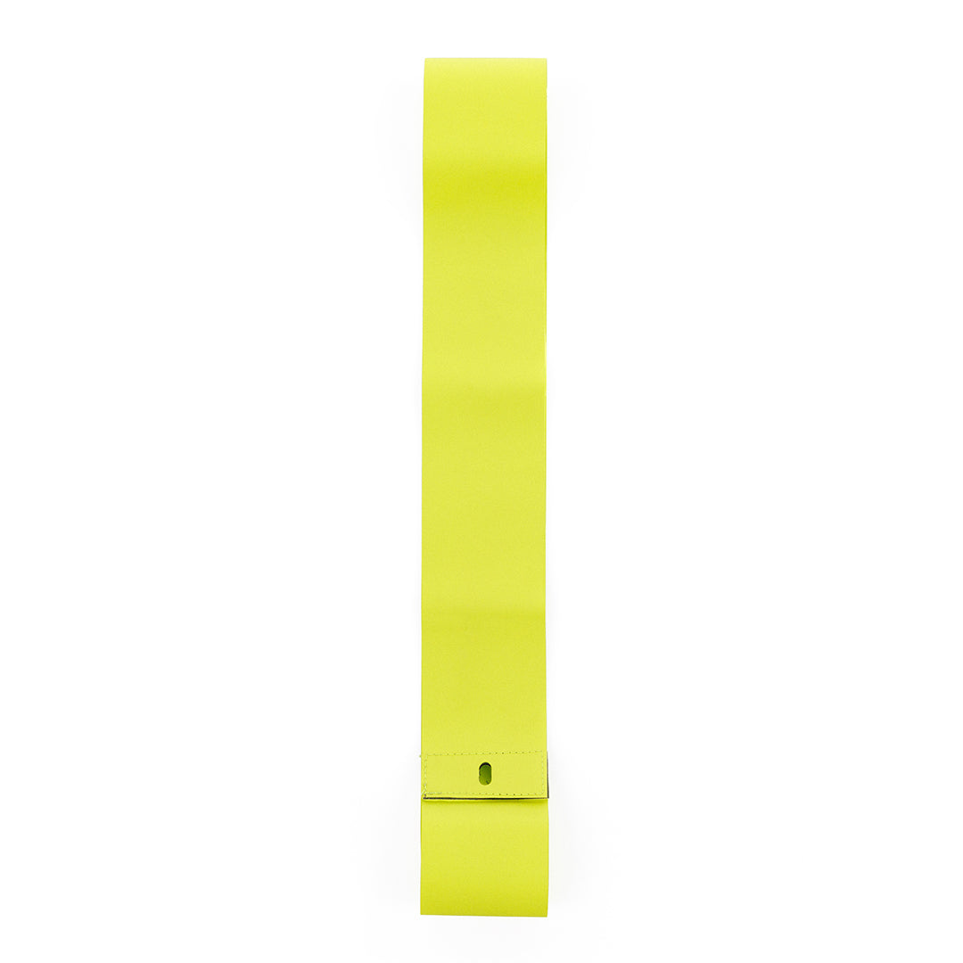 Yellow tire liner strip layed out on white background showing tire valve hole