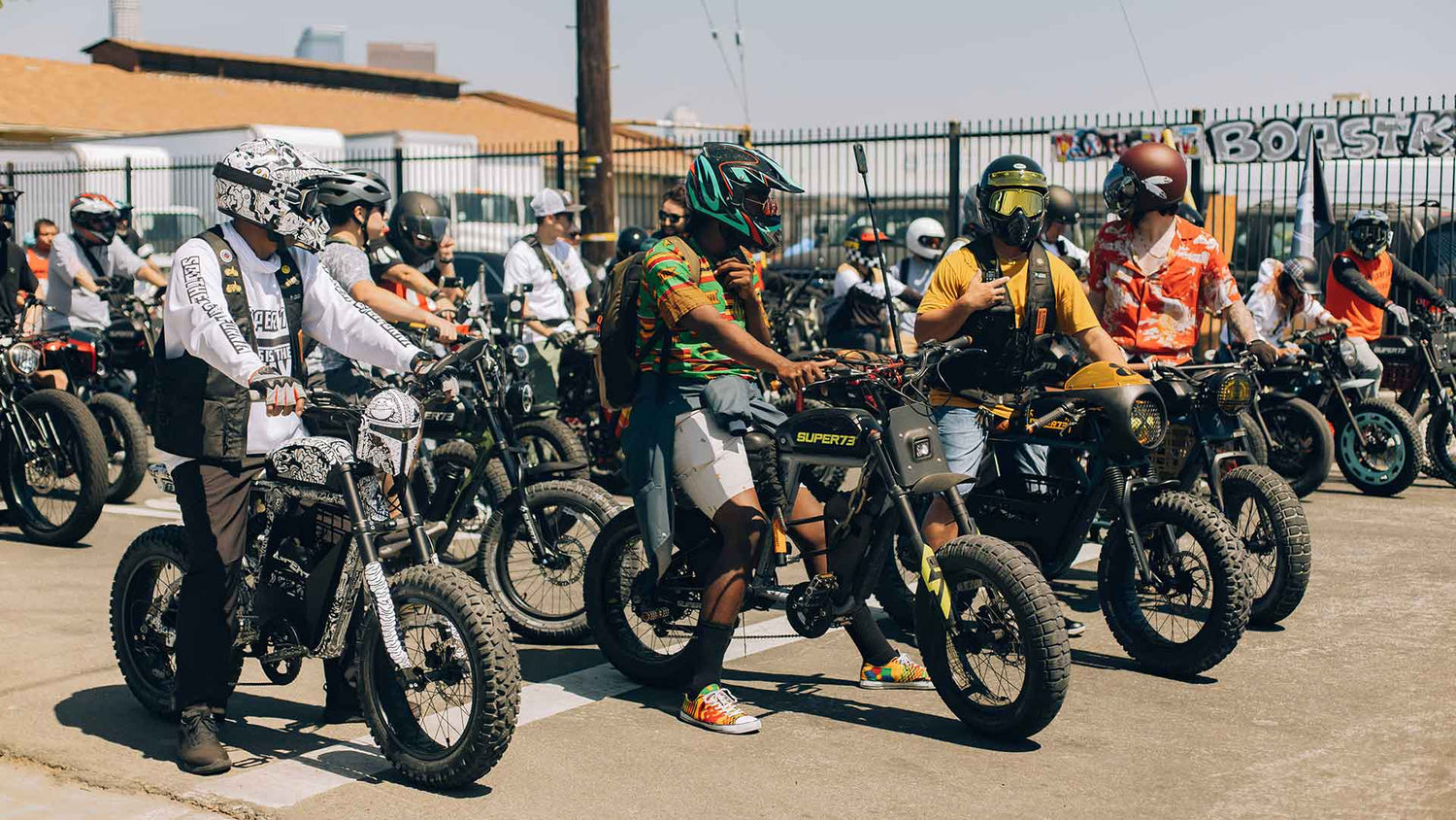 Group of Super73 riders lined up on their bikes at a group ride