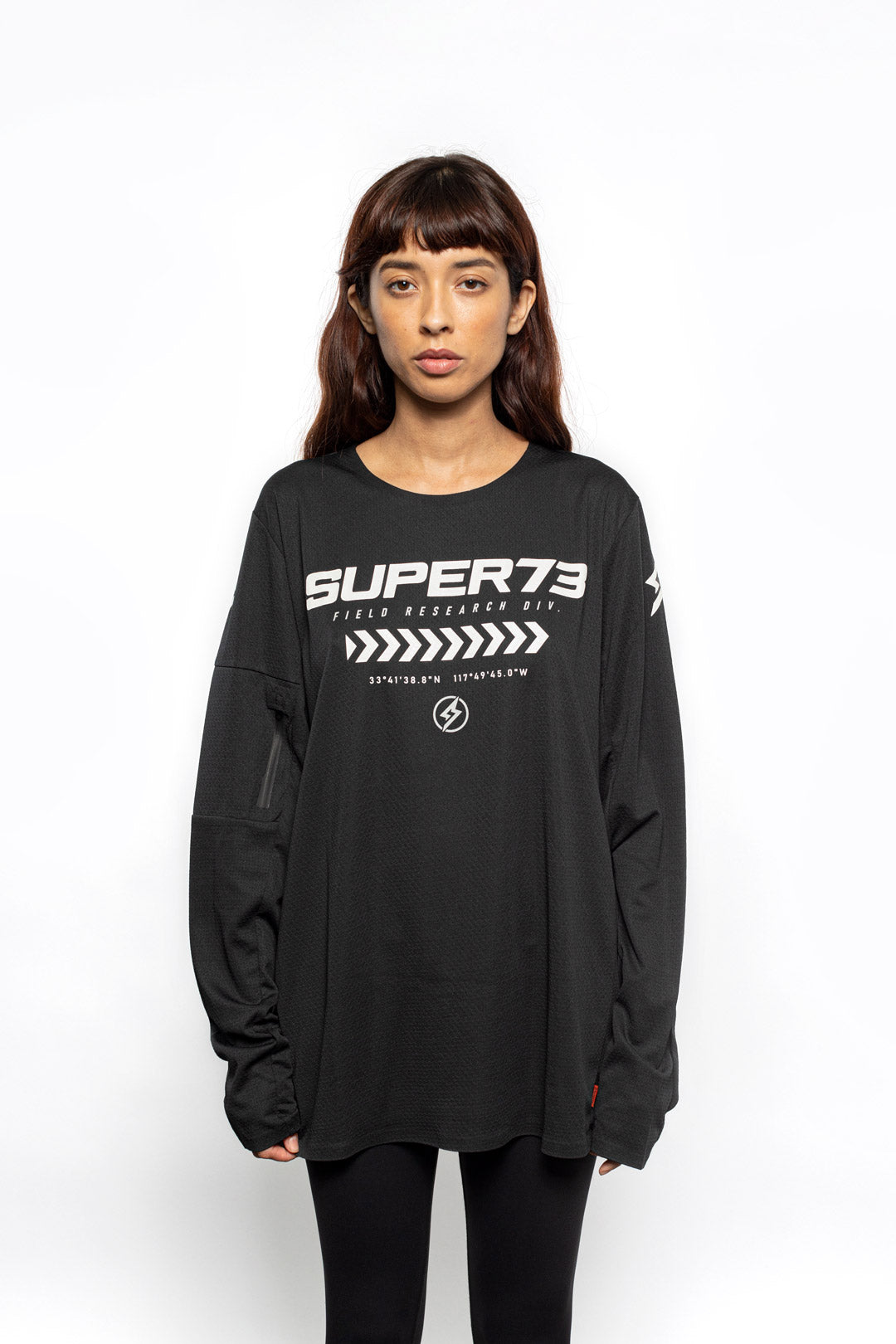Female model front view of black Premium long sleeve athletic moto hoon jersey.