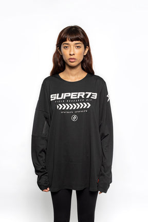 Female model front view of black Premium long sleeve athletic moto hoon jersey.
