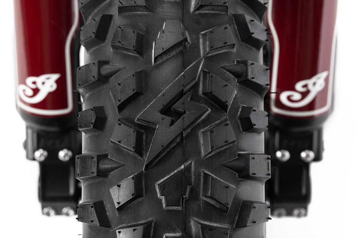 Closeup shot of Super73 Indian S2 GRZLY tires featuring Icon logo in tire tread