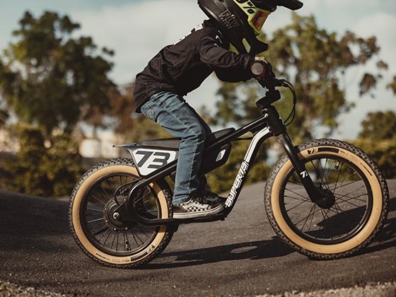 A boy riding his Obsidian K1D while wearing a helmet