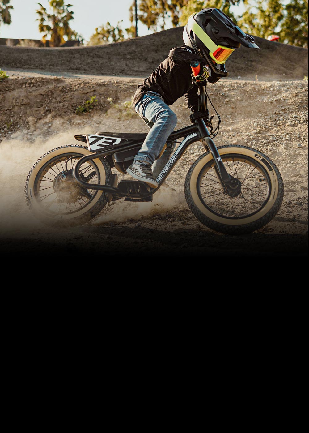 A kid riding his K1D on a pump track having the best time of his life.