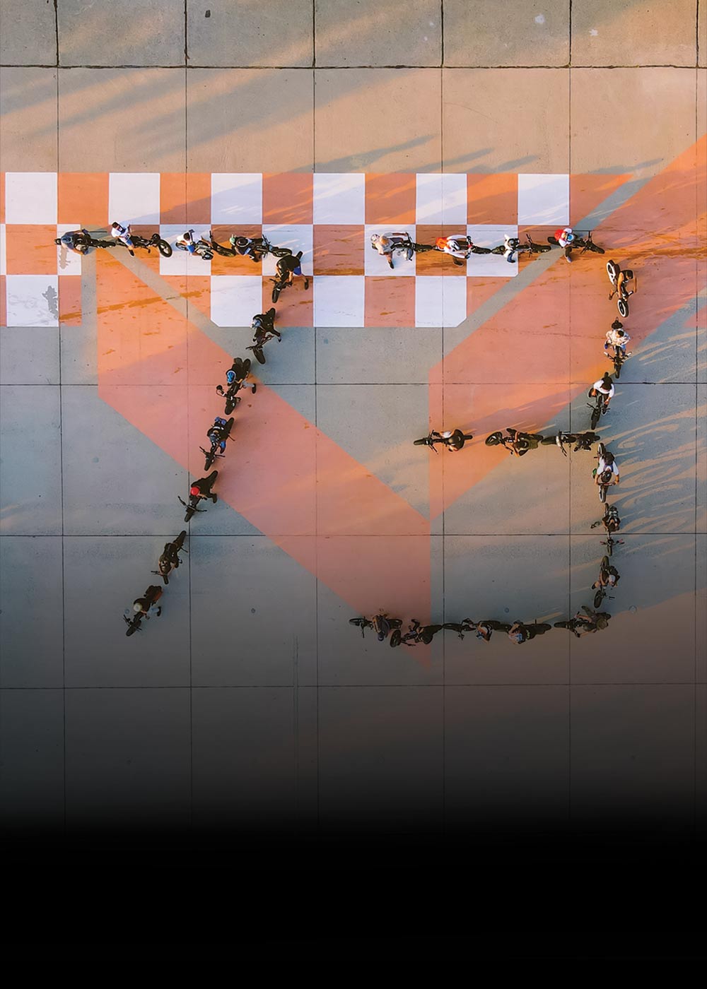 Aerial view of riders lined up in the shape of 73