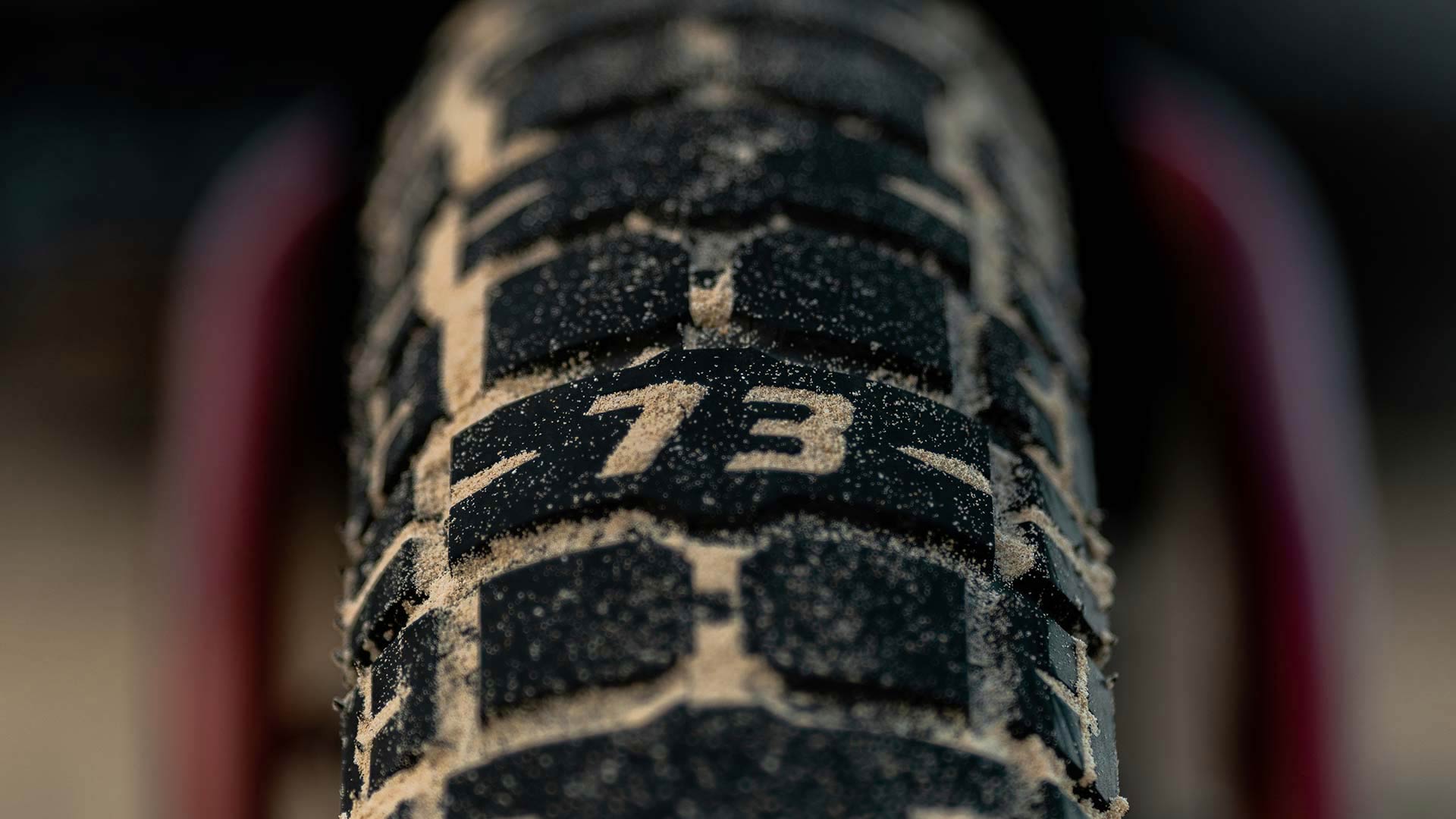 SUPER73 e-bike tire in the sand.