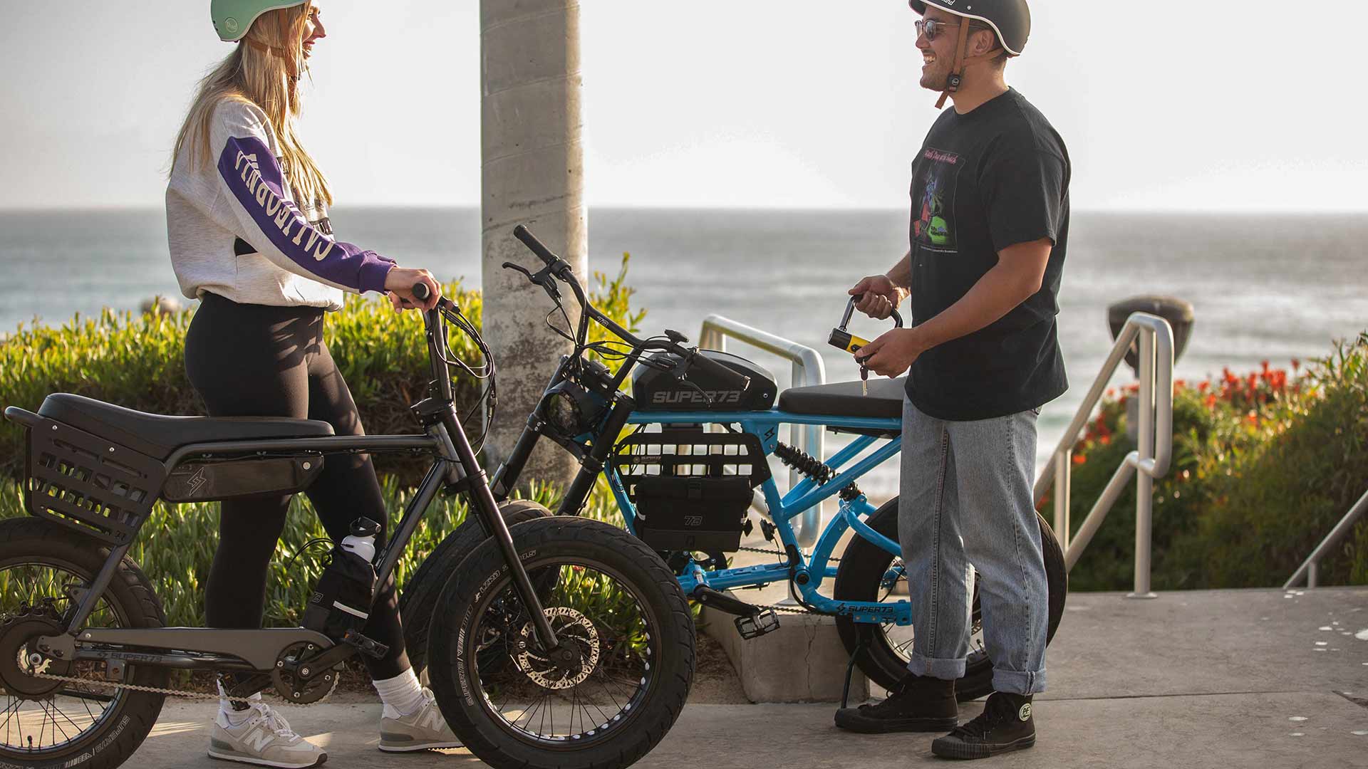 Two riders discussing safety on their SUPER73 e-bike