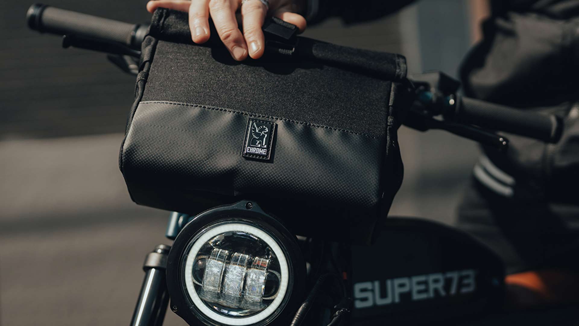 Chrome brand carry bag attached to a Super73 bike.