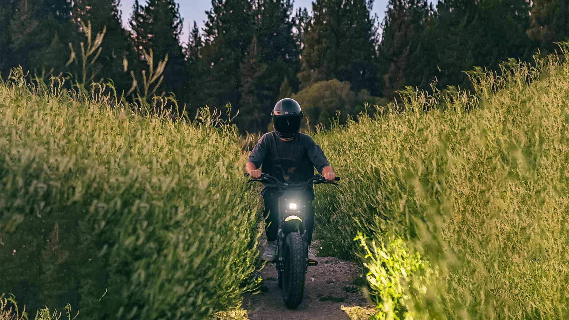 Super73 ebike passing through trail of tall grass