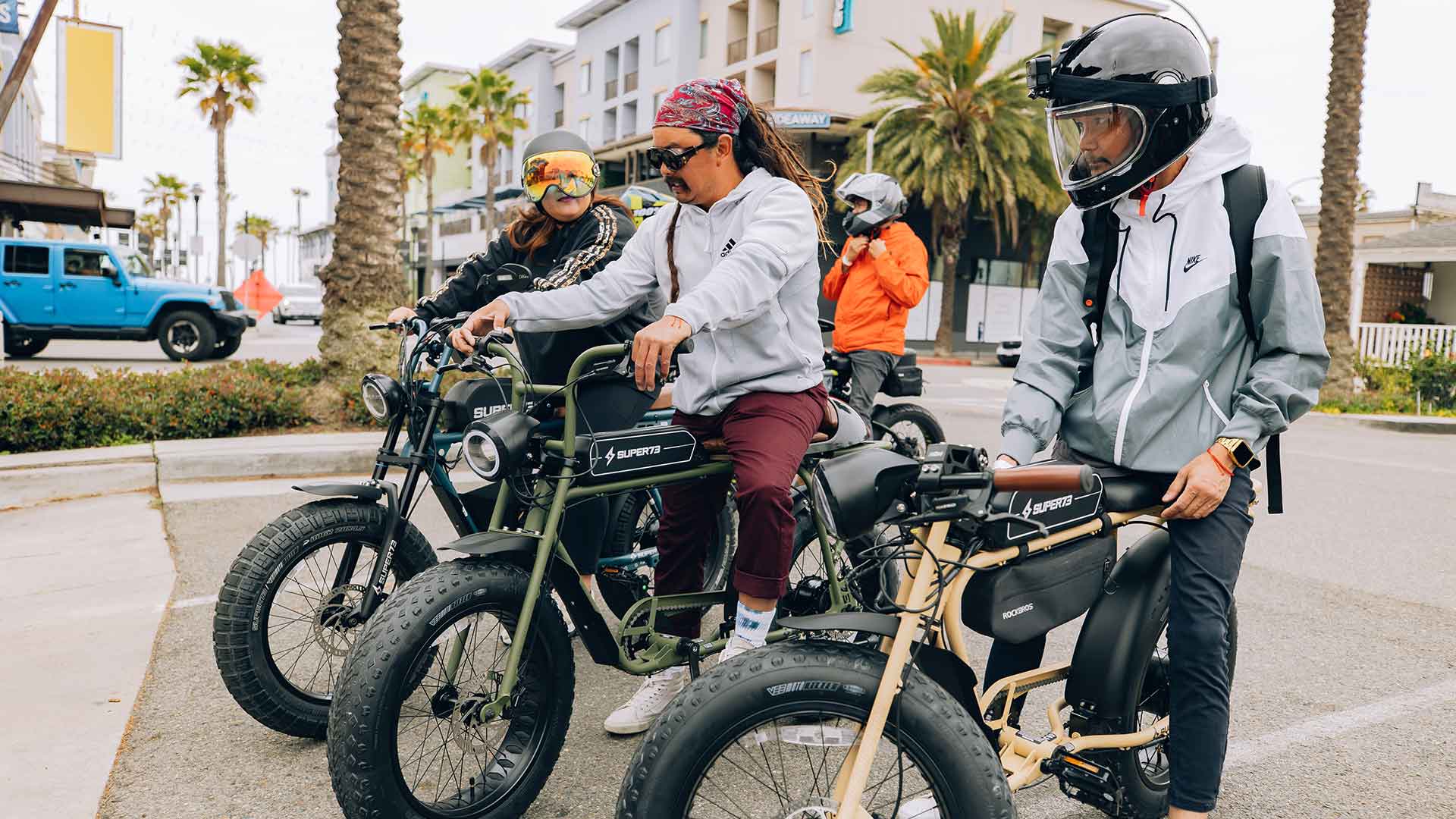 Group Riders inspecting their Super73 ebikes