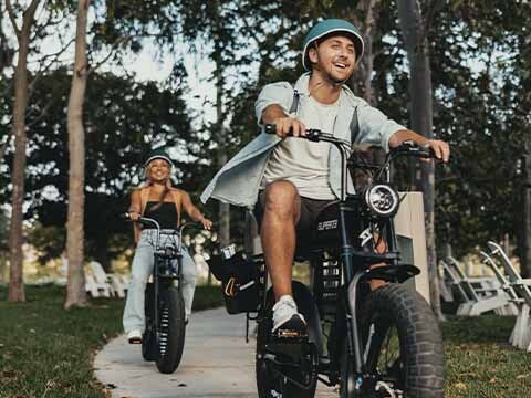 Rider cruising down the street on a Super73 ebike wearing a helmet