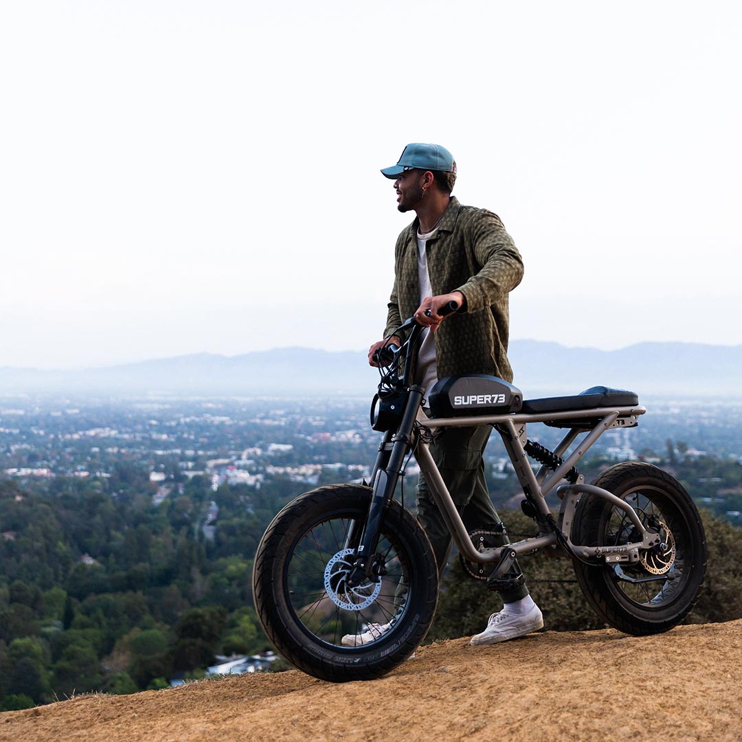 Rider with Super73 R Brooklyn ebike over looking the town from the hillside