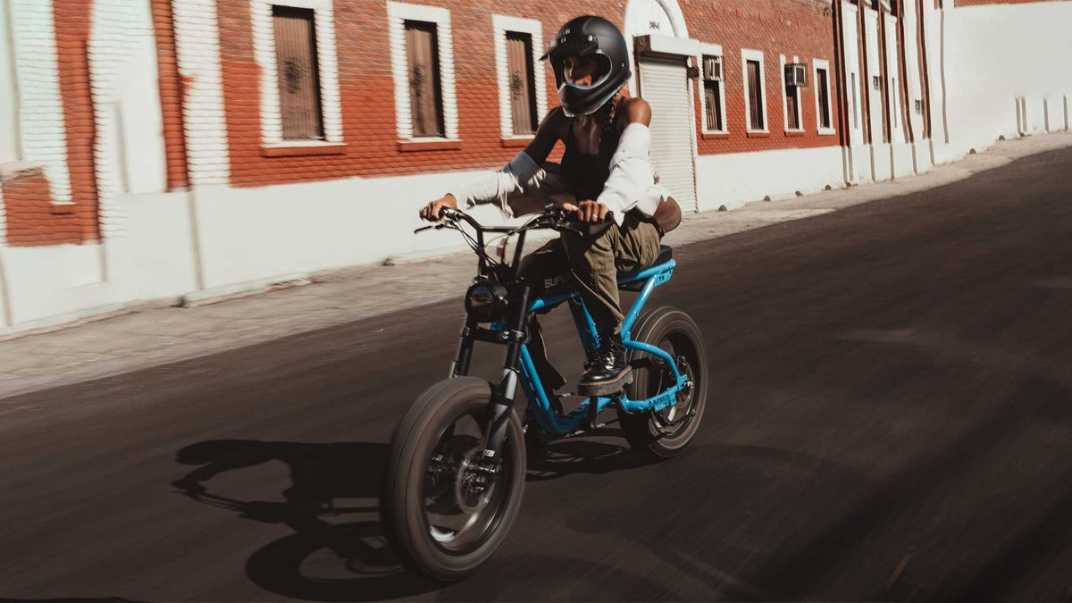 A rider cruising comfortably down the road on a Super73 ebike