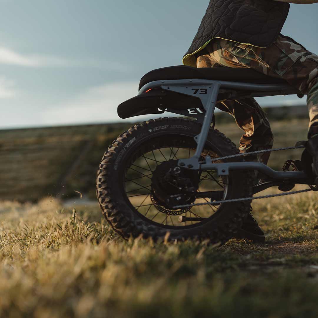 Lifestyle image of a rider sitting on the S Adventure on a grassy field.