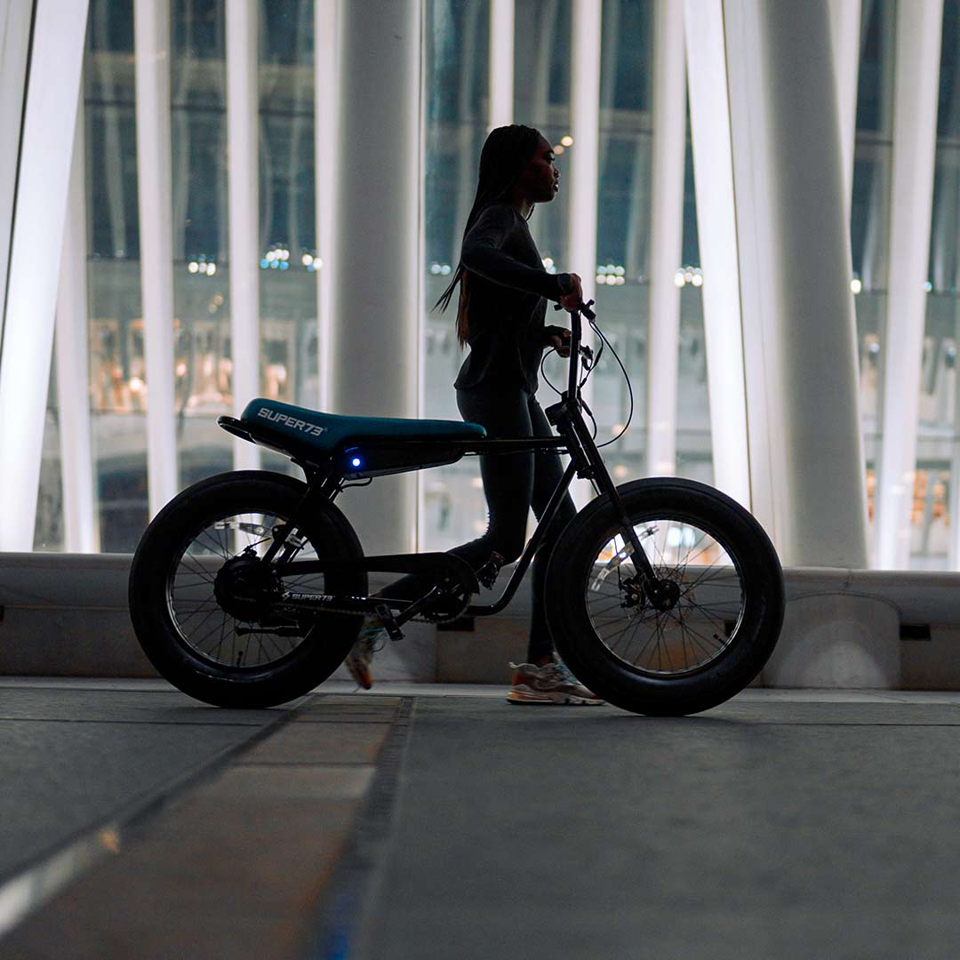 Night silhouette shot of rider walking Super73 Z1 ebike