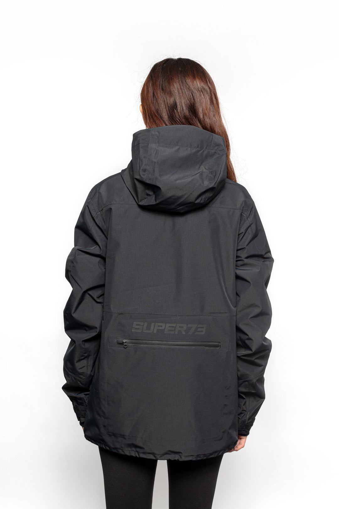 Back view of Female model wearing Royce Harrington Jacket in black colorway.