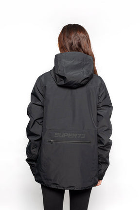 Back view of Female model wearing Royce Harrington Jacket in black colorway.