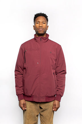 Male model wearing Royce Harrington Jacket in burgundy colorway.