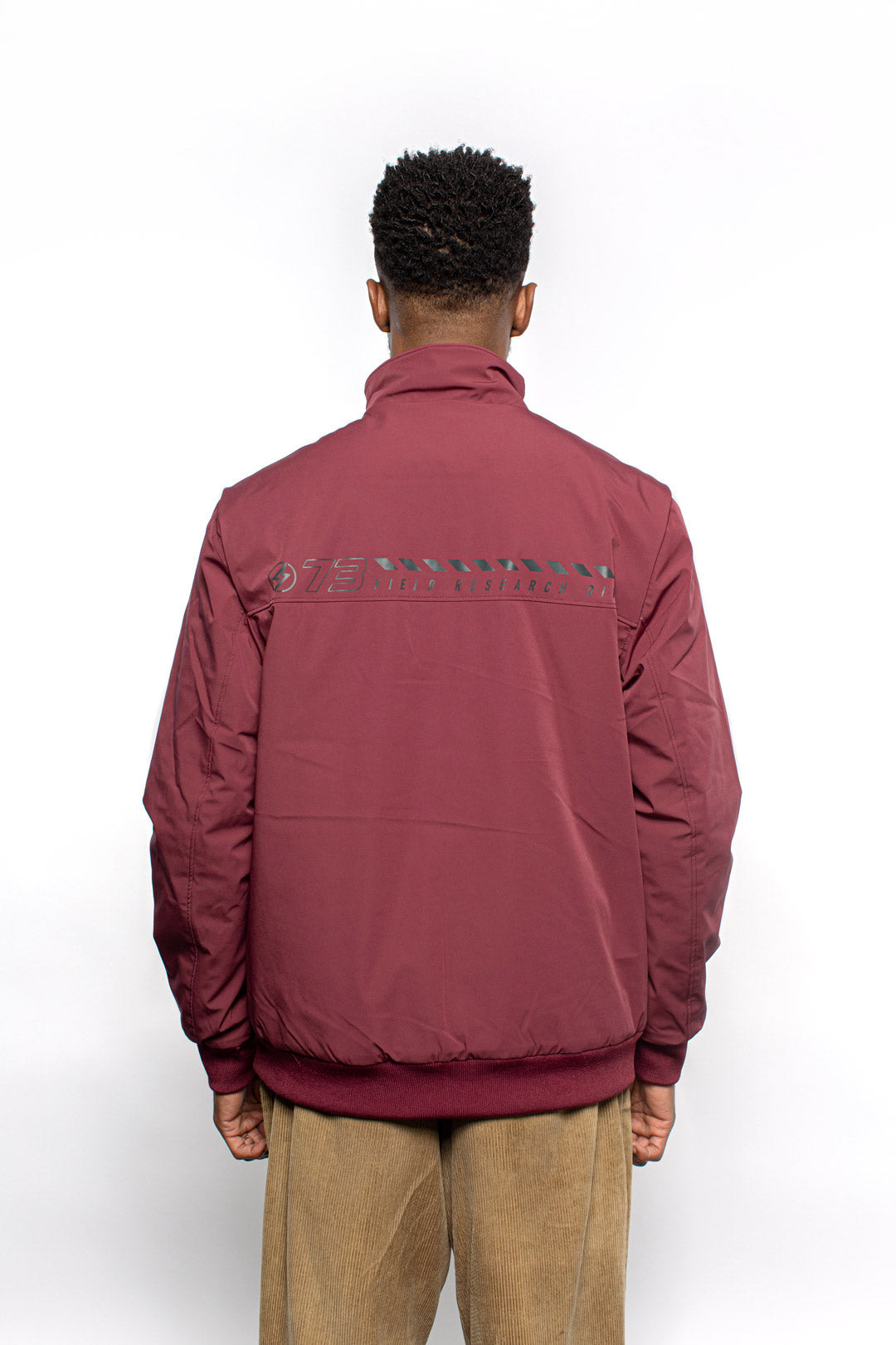 Male model wearing Royce Harrington Jacket in burgundy colorway.