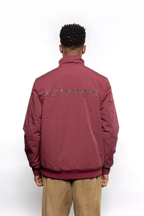 Male model wearing Royce Harrington Jacket in burgundy colorway.