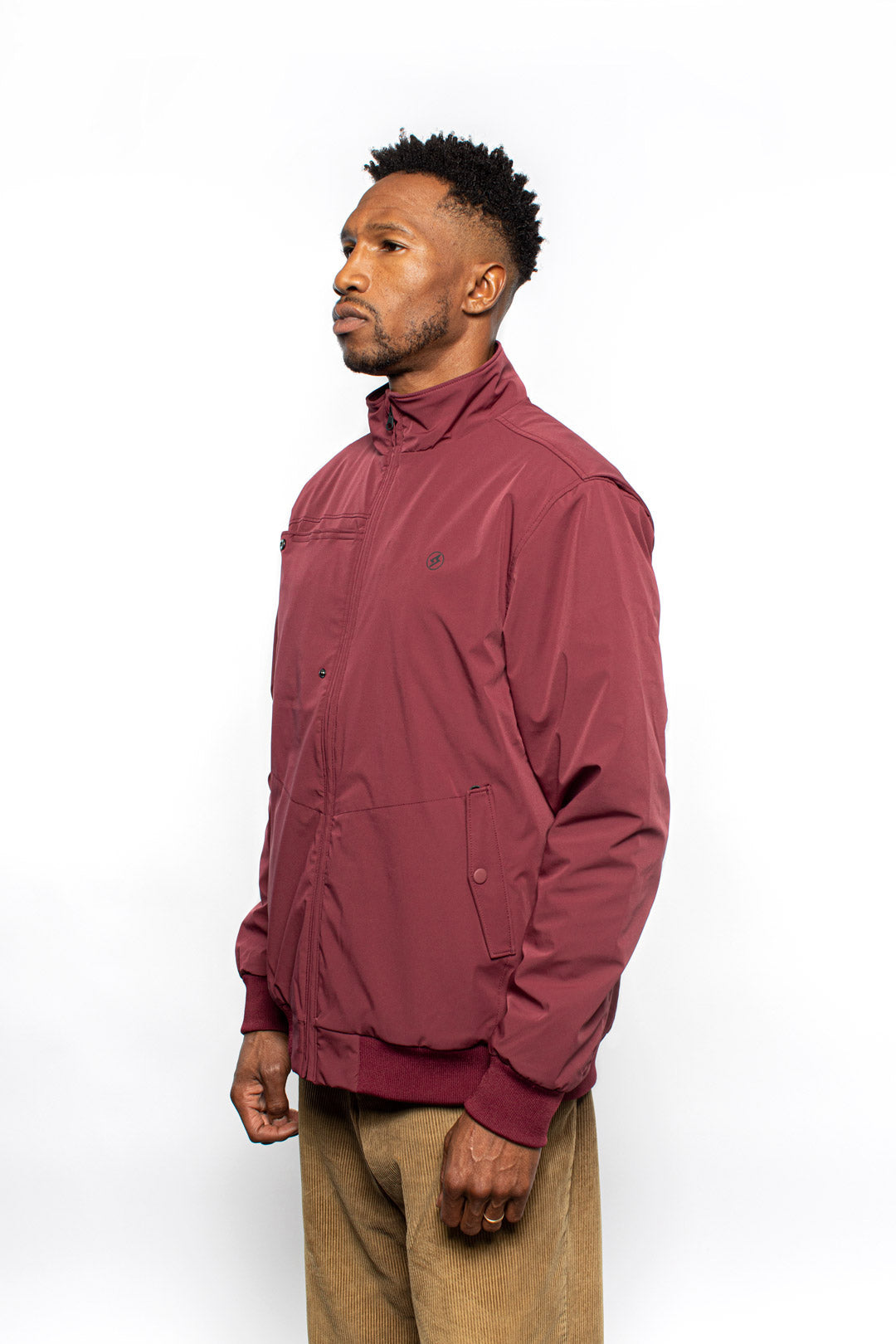 Side view of male model wearing Royce Harrington Jacket in burgundy colorway.
