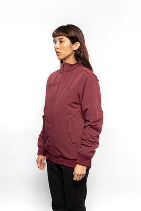 Female model wearing Royce Harrington Jacket in burgundy colorway.