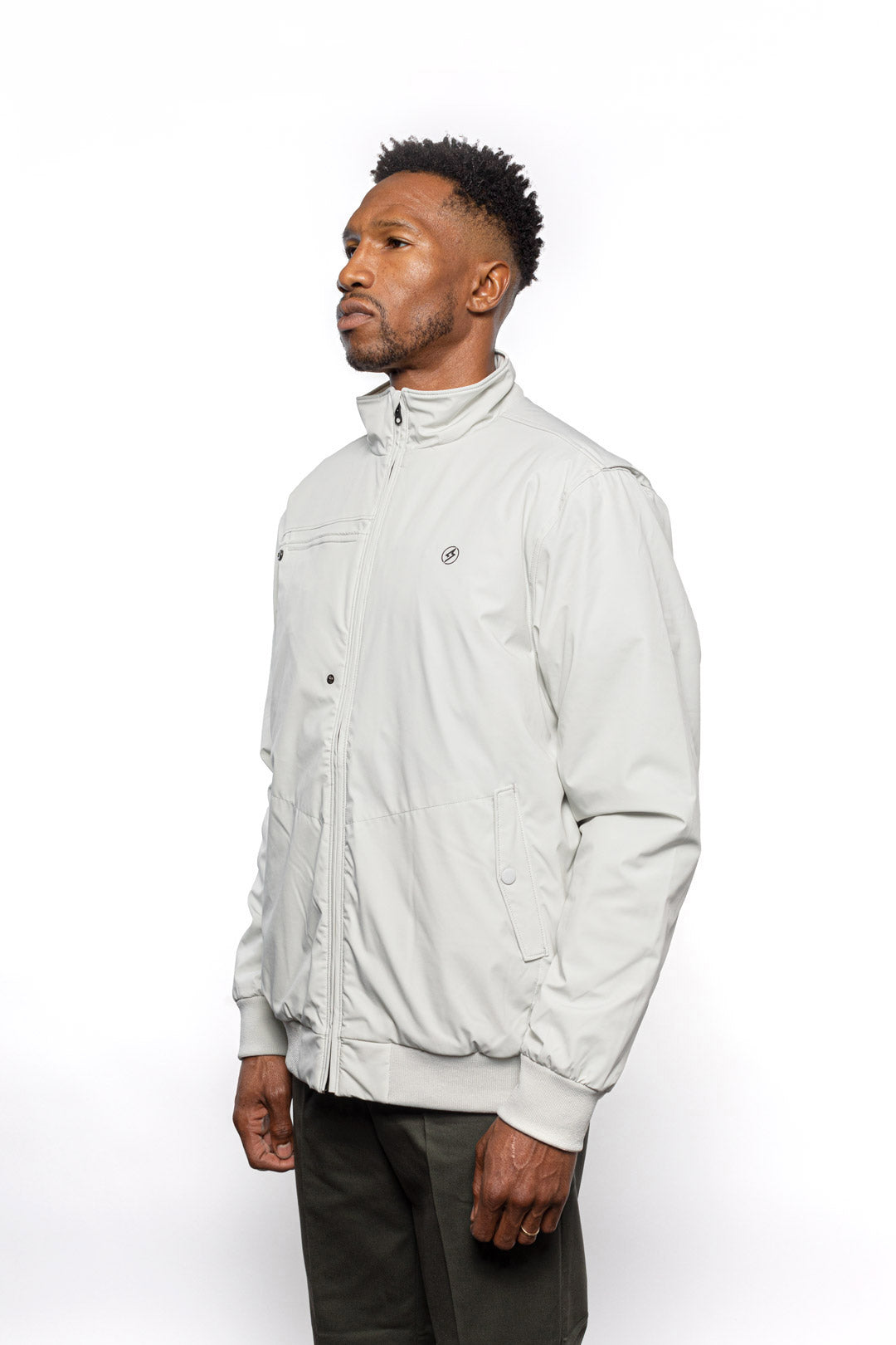 Side view of Male model wearing Royce Harrington Jacket in chalk colorway.