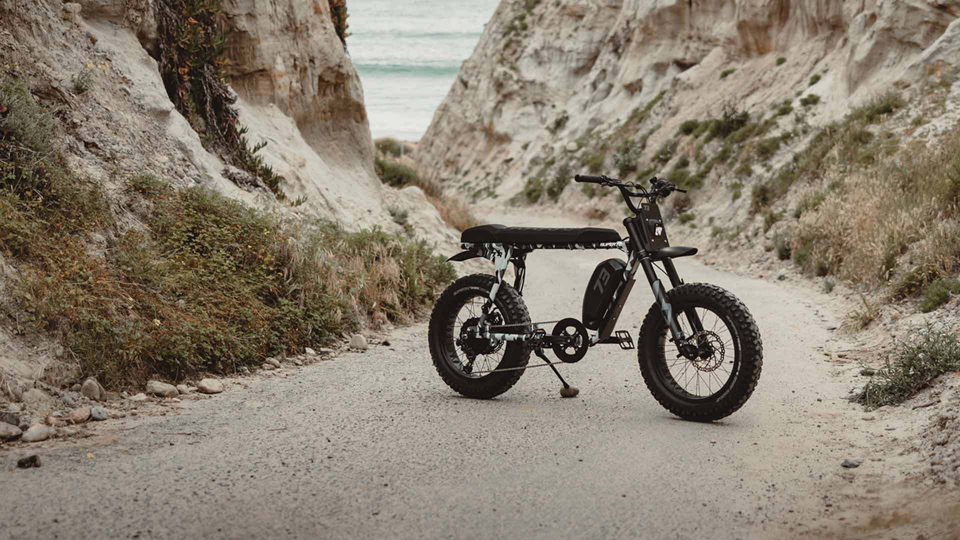 A Super73 S-Series ebike leaning on a kickstand in the middle of a dirt road