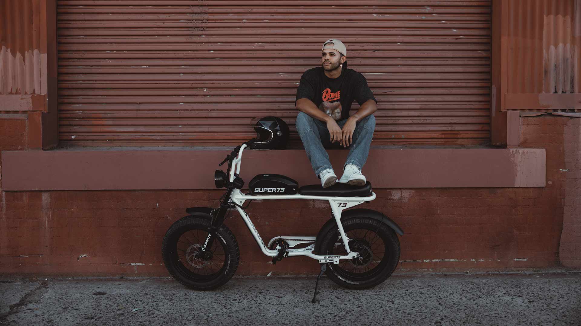 SUPER73 rider taking a break from riding their e-bike through urban streets.
