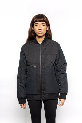 Female model wearing Sipes Varsity Jacket in black colorway.