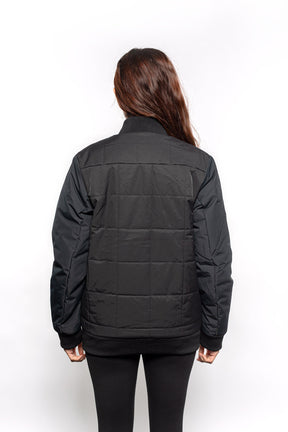 Back view of Female model wearing Sipes Varsity Jacket in black colorway.