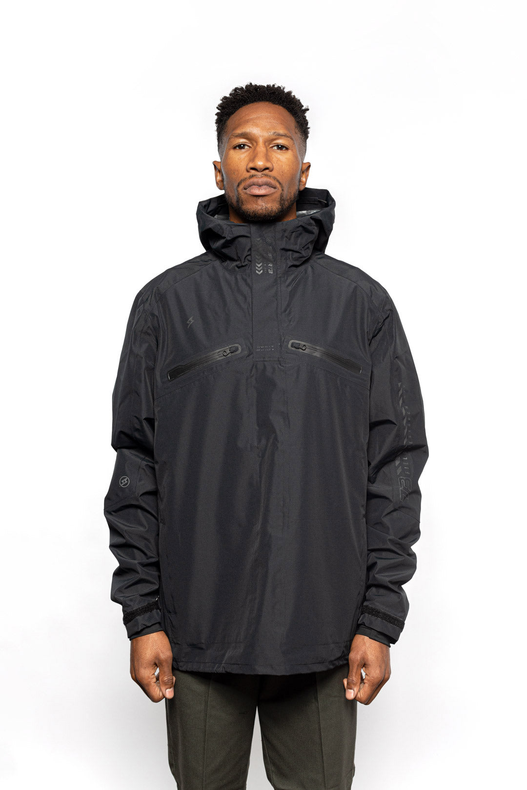 Male model wearing Vale Packable Anorak in black colorway.