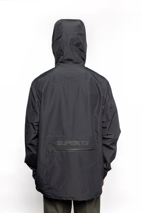 Male model wearing Vale Packable Anorak in black colorway.
