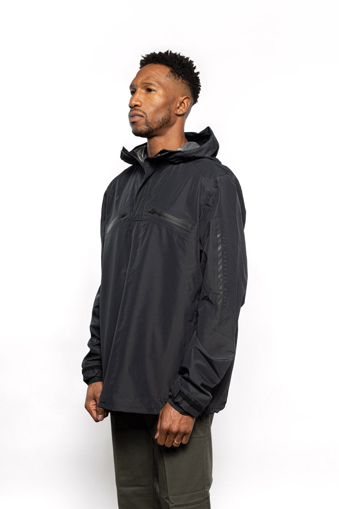 Side view of Male model wearing Vale Packable Anorak in black colorway.