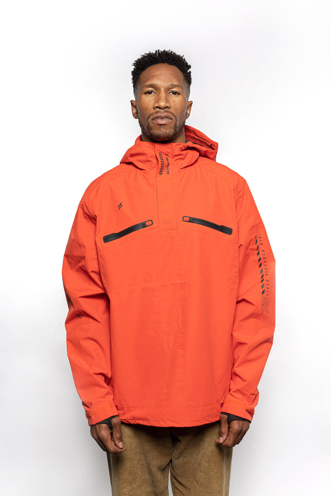 Male model wearing Vale Packable Anorak in blood orange colorway.