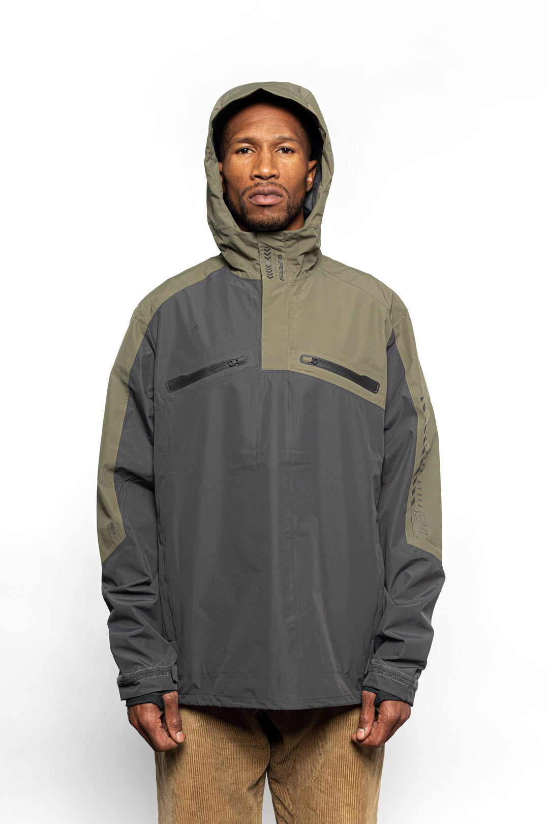 Male model wearing Vale Packable Anorak in Dark Fatigue colorway with hood on.