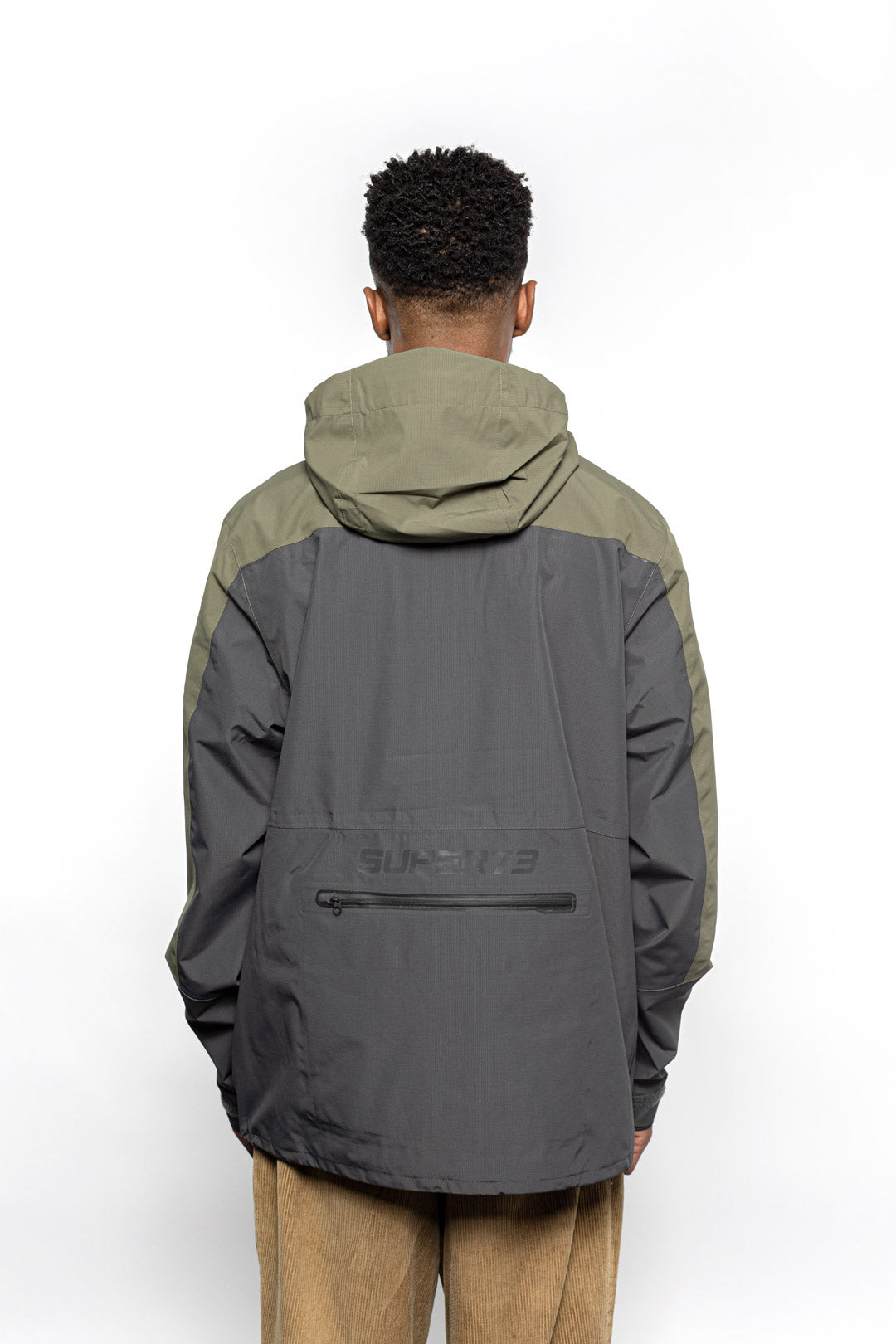 Back view of Male model wearing Vale Packable Anorak in Dark Fatigue colorway.